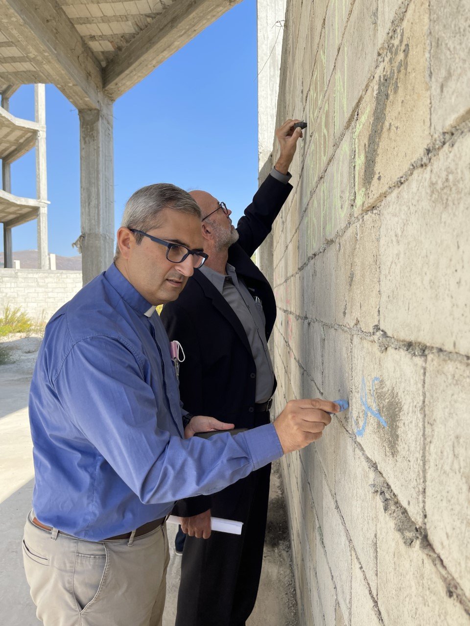  Rev Elias Jabbour, Pastor of the Presbyterian Church in Yazdia, writes a blessing on the Retreat Center walls 