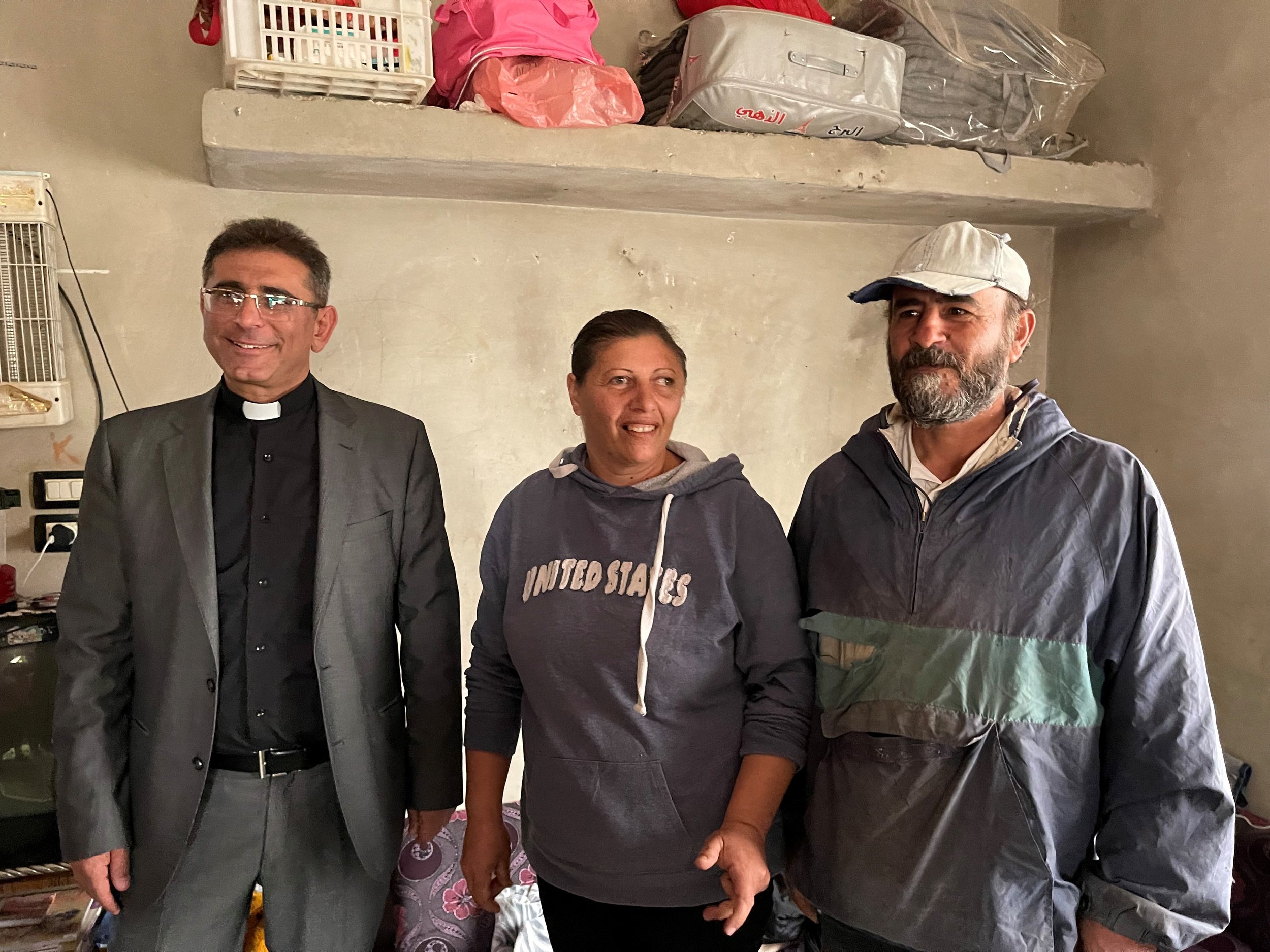  Rev. Saleem Farah with Ra’ida and Mazen whose home had been badly damaged by terrorists and all their belongings taken. They thank God that their lives were preserved along with their young children.   