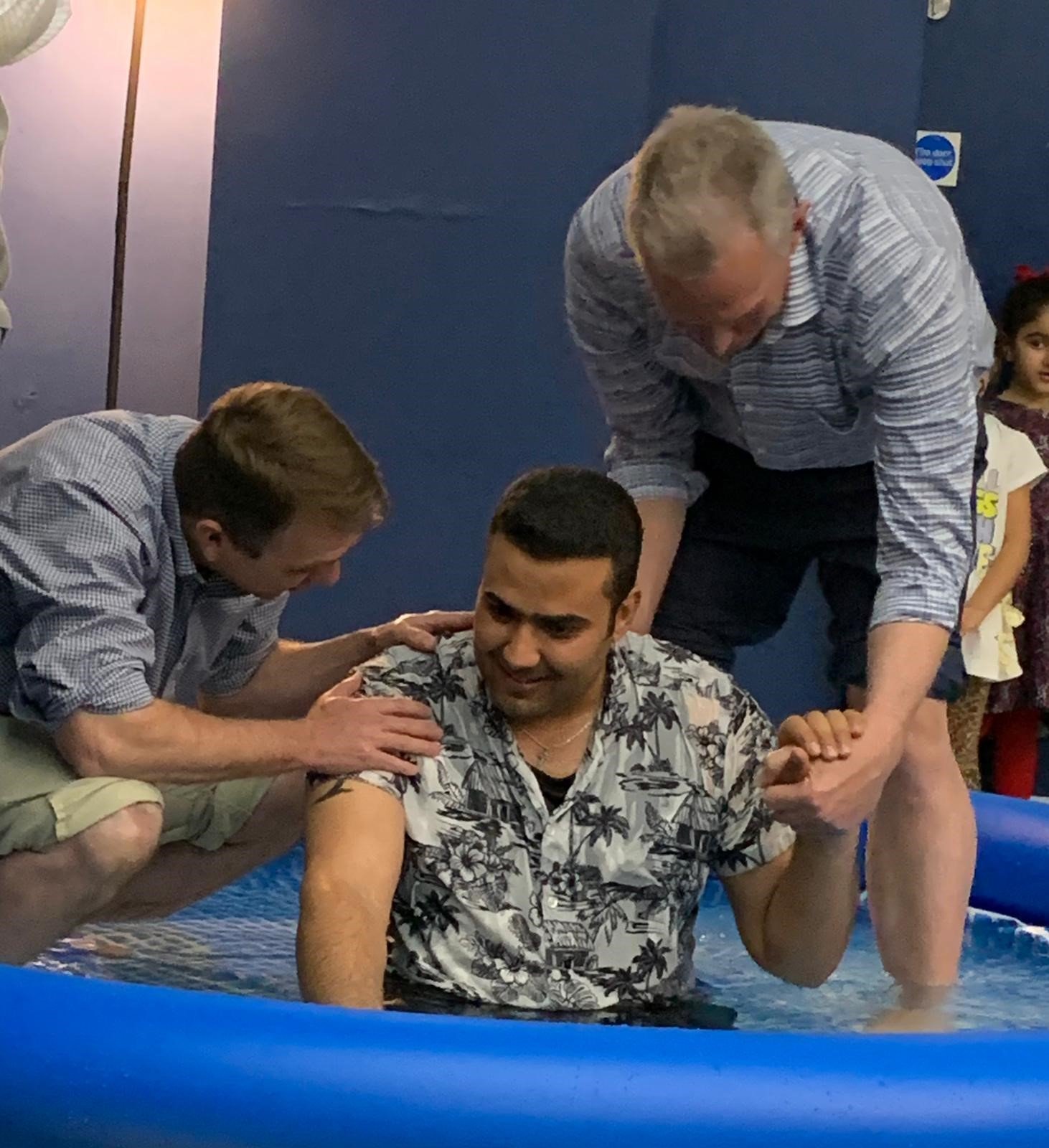   Shawn Hevener and Mark Mueller baptizing Ahmed  