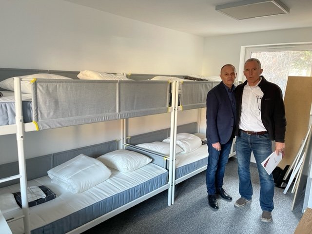   Mark Mueller and Piotr Nowak in a dormitory built with The Outreach Foundation funds for a disabled woman from Ukraine who arrives with her children later this week.  