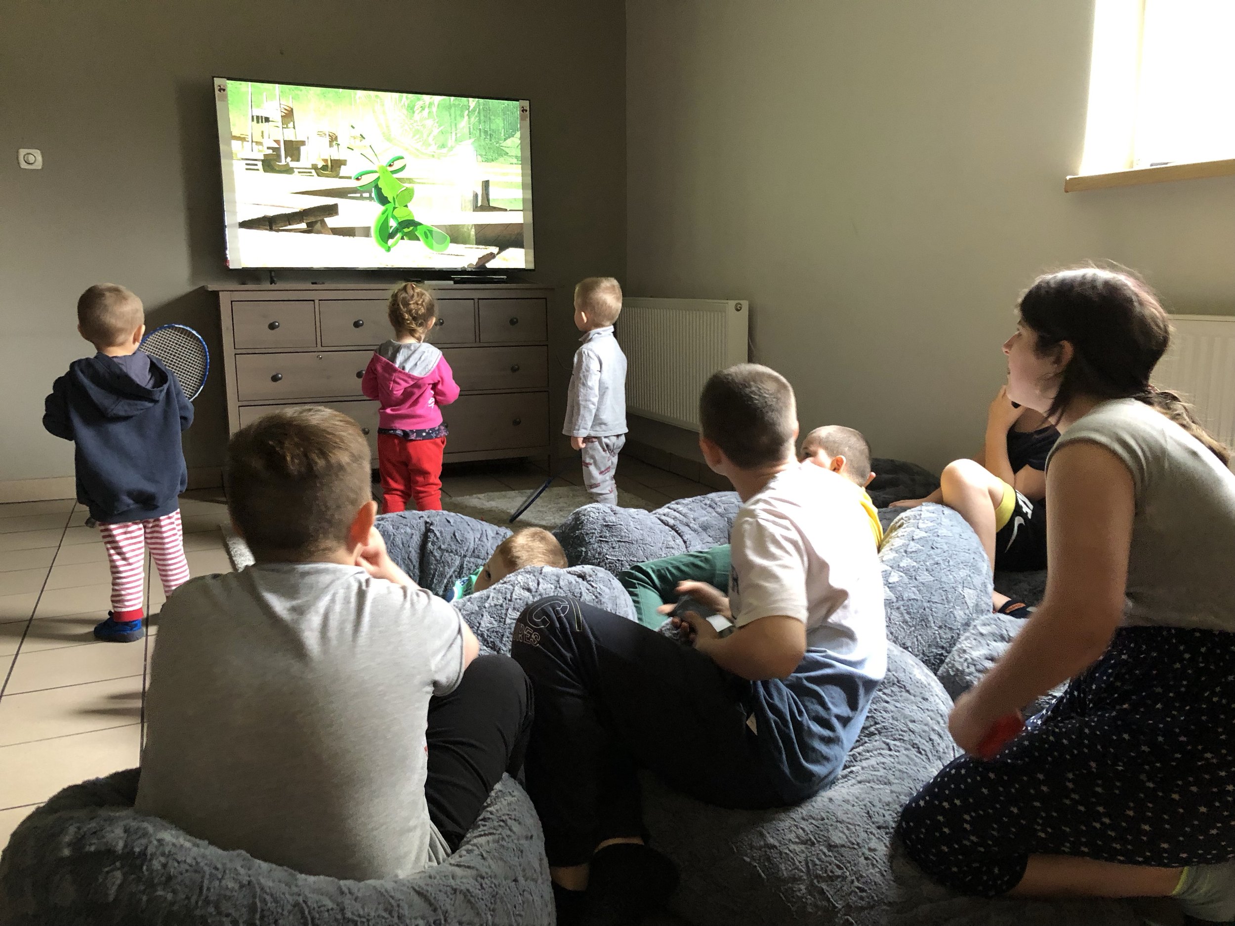 Children watch each other playing video games during their off time from online school