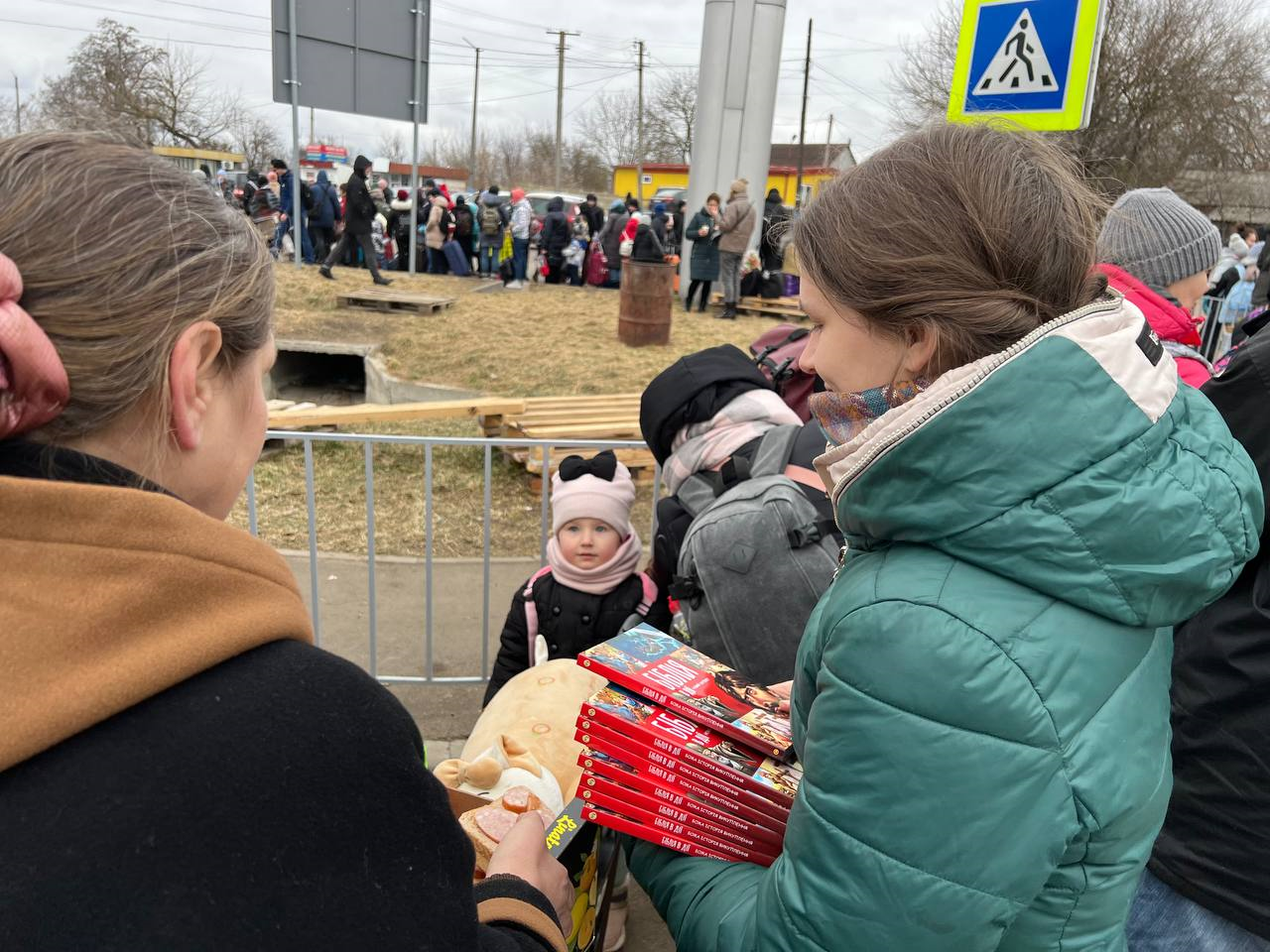 Displaced people in Western Ukraine stand in line waiting for Mission Eurasia’s “I-Care” boxes with food and spiritual resources.