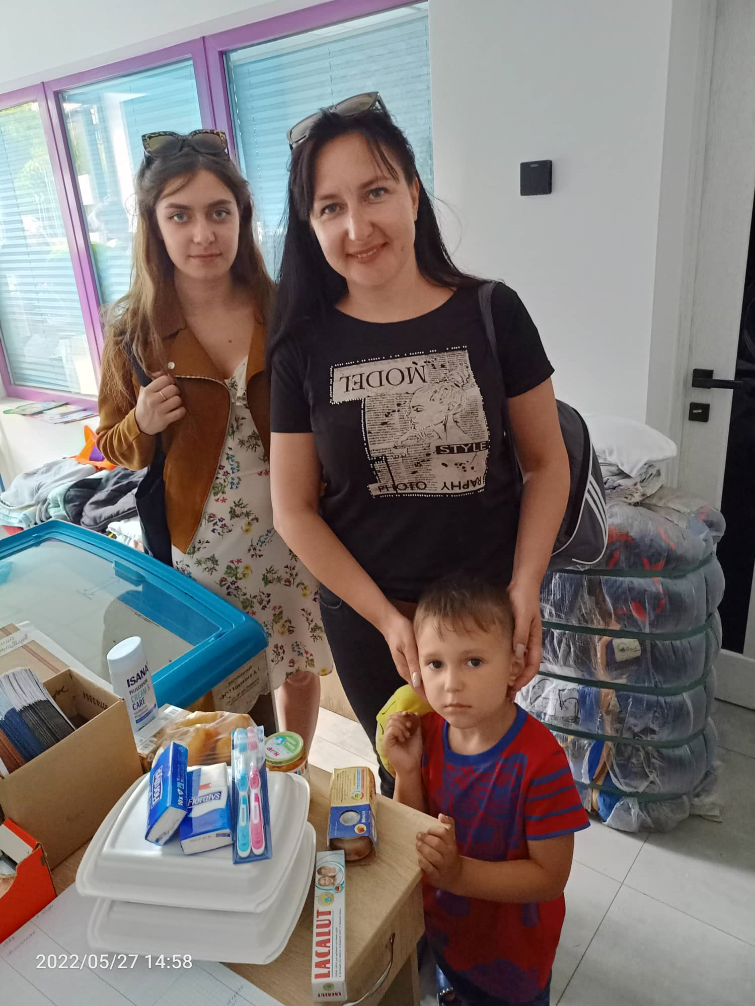 An internally displaced family receiving supplies in Lviv