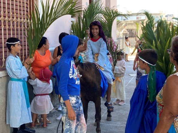  A reenactment of the triumphal entry – complete with Jesus riding on a real pony and both children and adults welcoming him waving palm branches. 