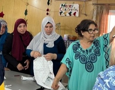  Izdihar Kassis, Together for the Family director shows off the sewing class and its work 