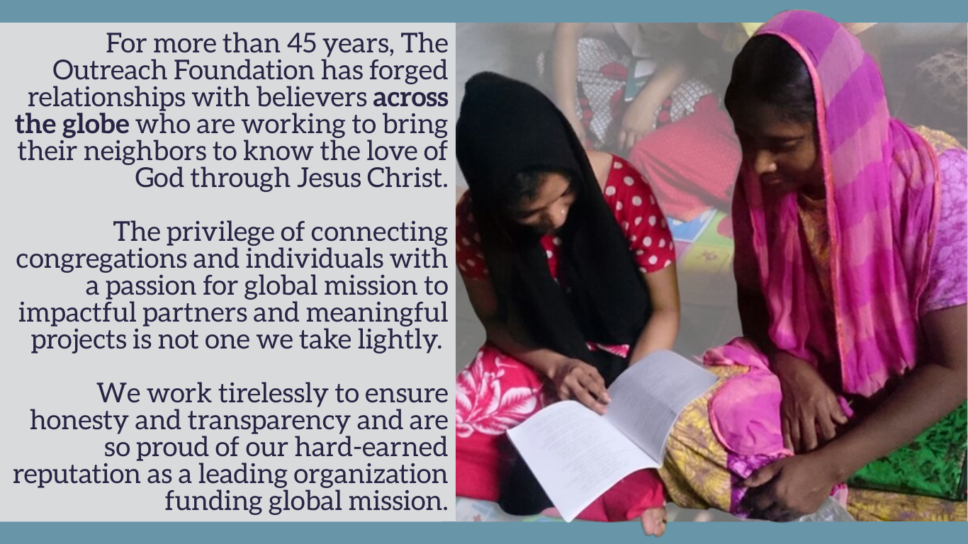 An image of two women wearing headscarves bend over a booklet