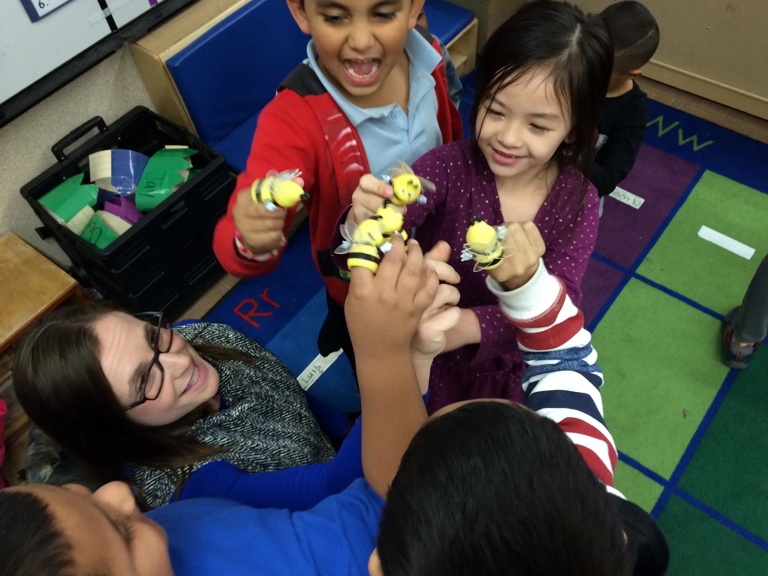 Teaching Artist Hannah Dworkin and the Story Explorers act out a scene with bee puppets.