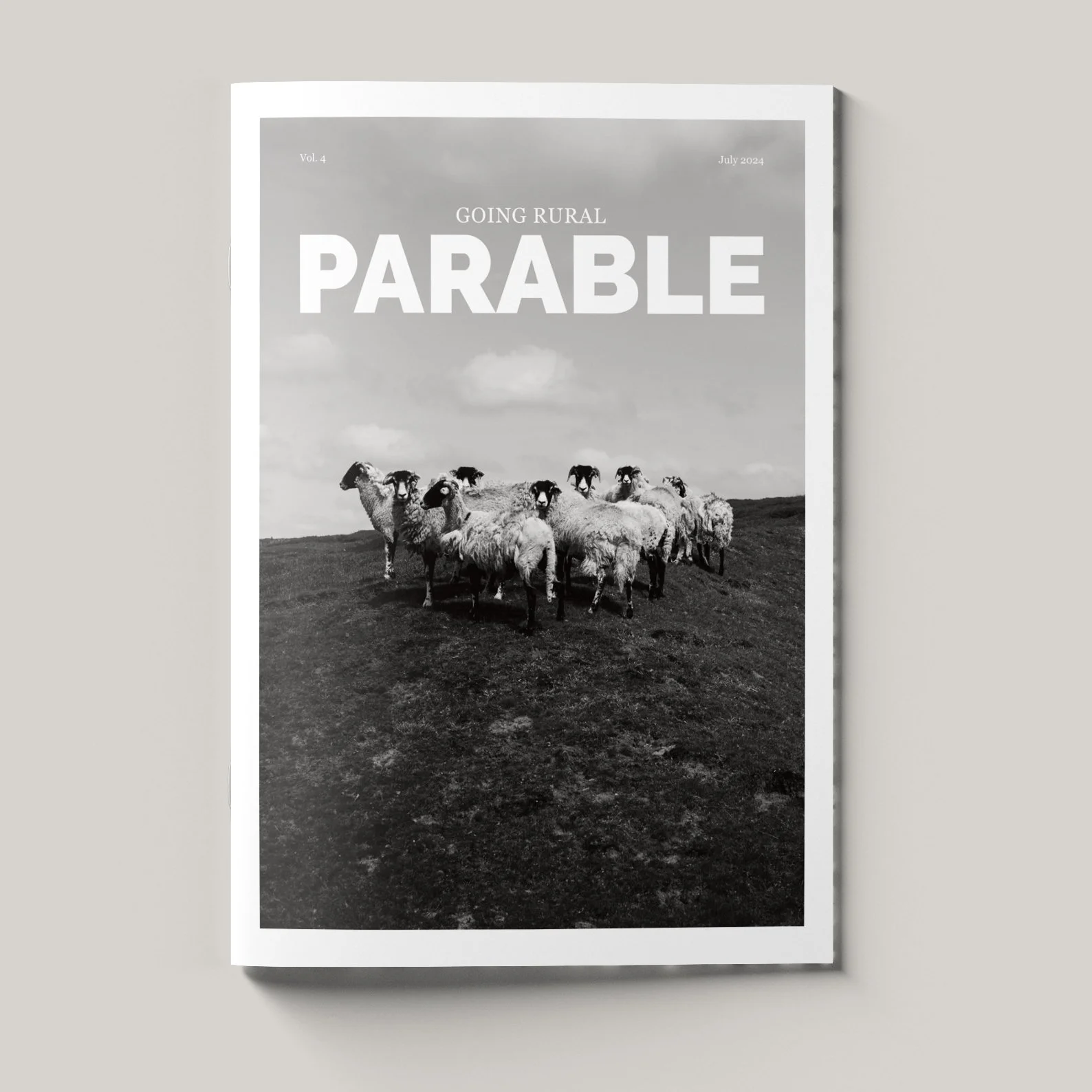 A black-and-white magazine cover with a photo of sheep on a rural landscape, with text reading "Going Rural Parable July 2024".