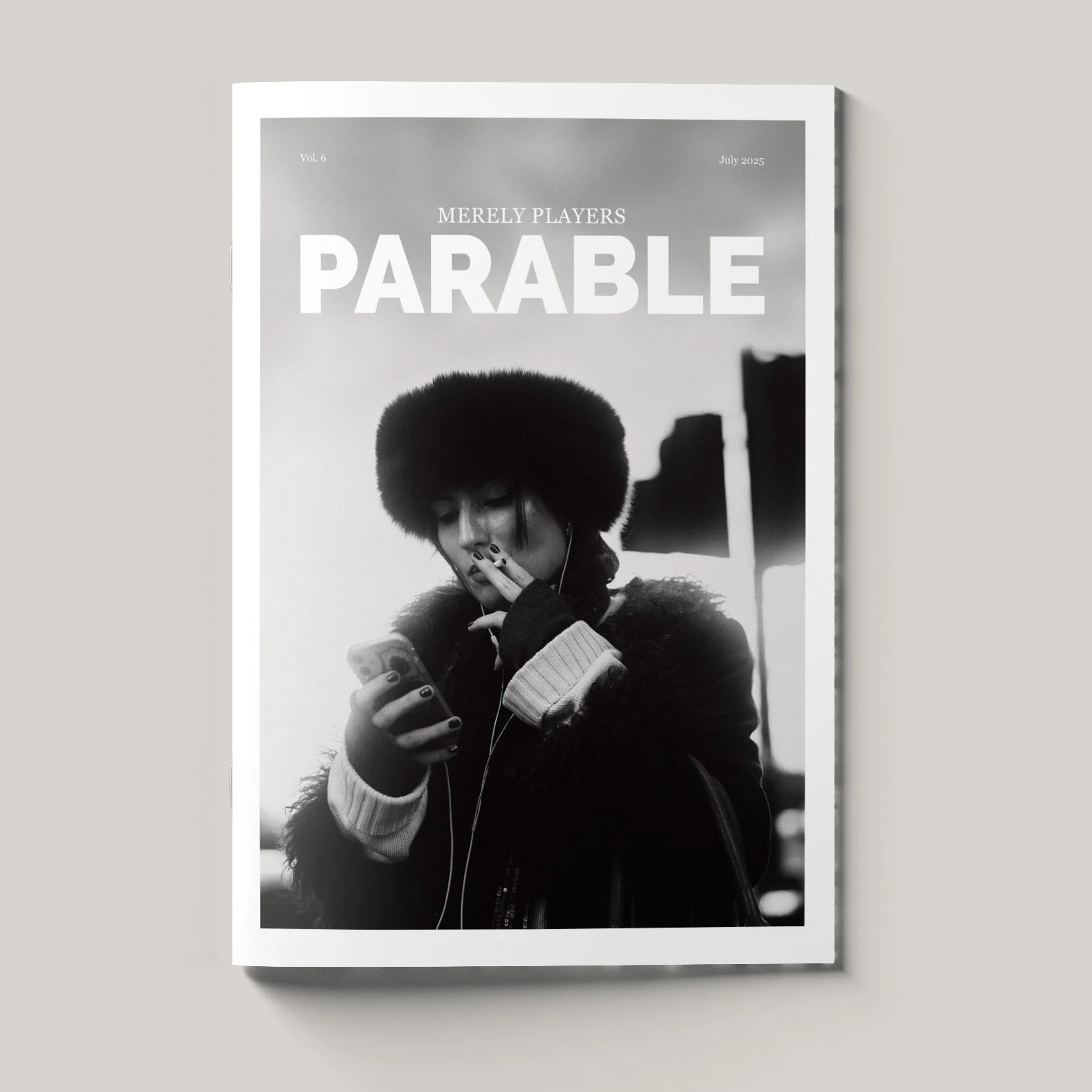 Black and white magazine cover featuring a woman looking at her phone, wearing a large fur hat and headphones, with the word 'PARABLE' in large letters at the top.