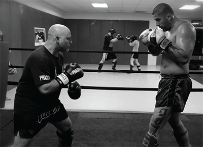 PHAS3 Coach Ben Brown (left) training with 7-time World Kickboxing Champion Rick Cheek