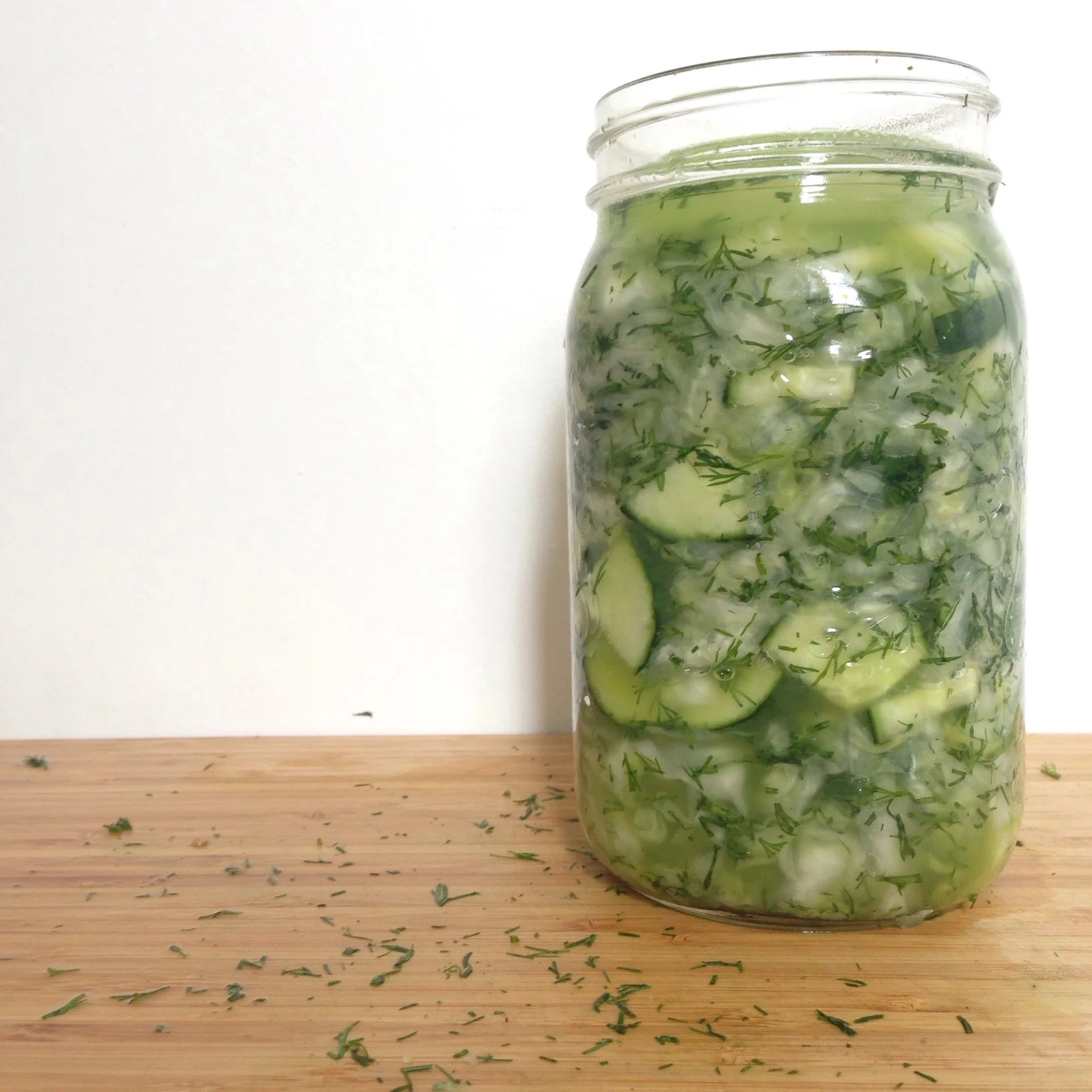 I used a glass fermenting weight to keep kraut submerged. Notice the herbs are still bright green and the brine is almost clear