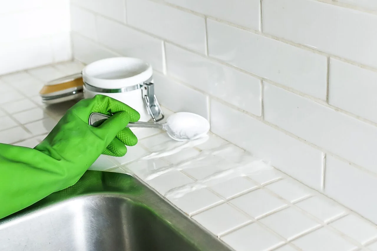 Use a spoon to apply to grout and leave on for 30 minutes