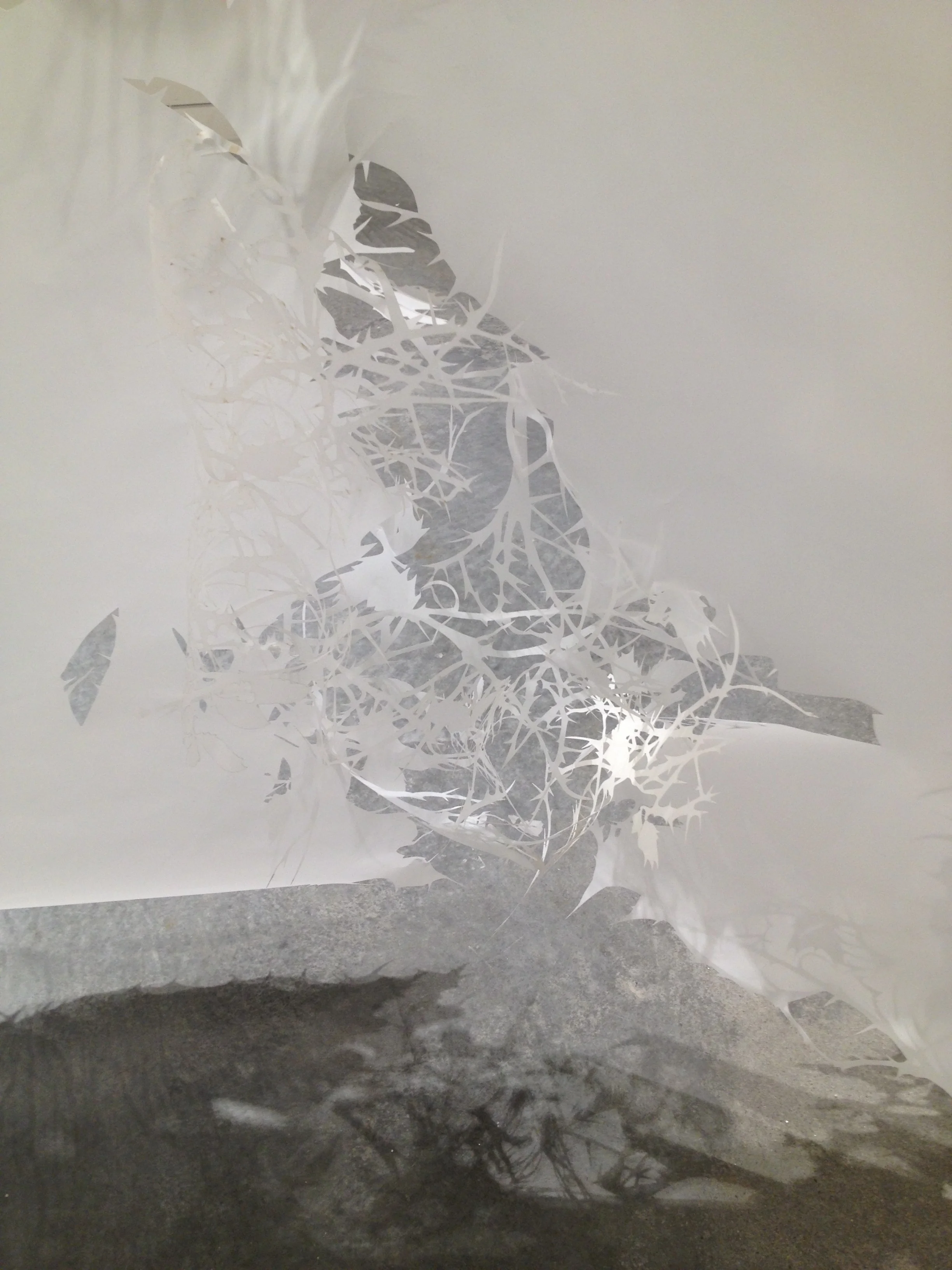   The Relentless Memorial   Installation view, inside panel shadows cast on concrete floor. 