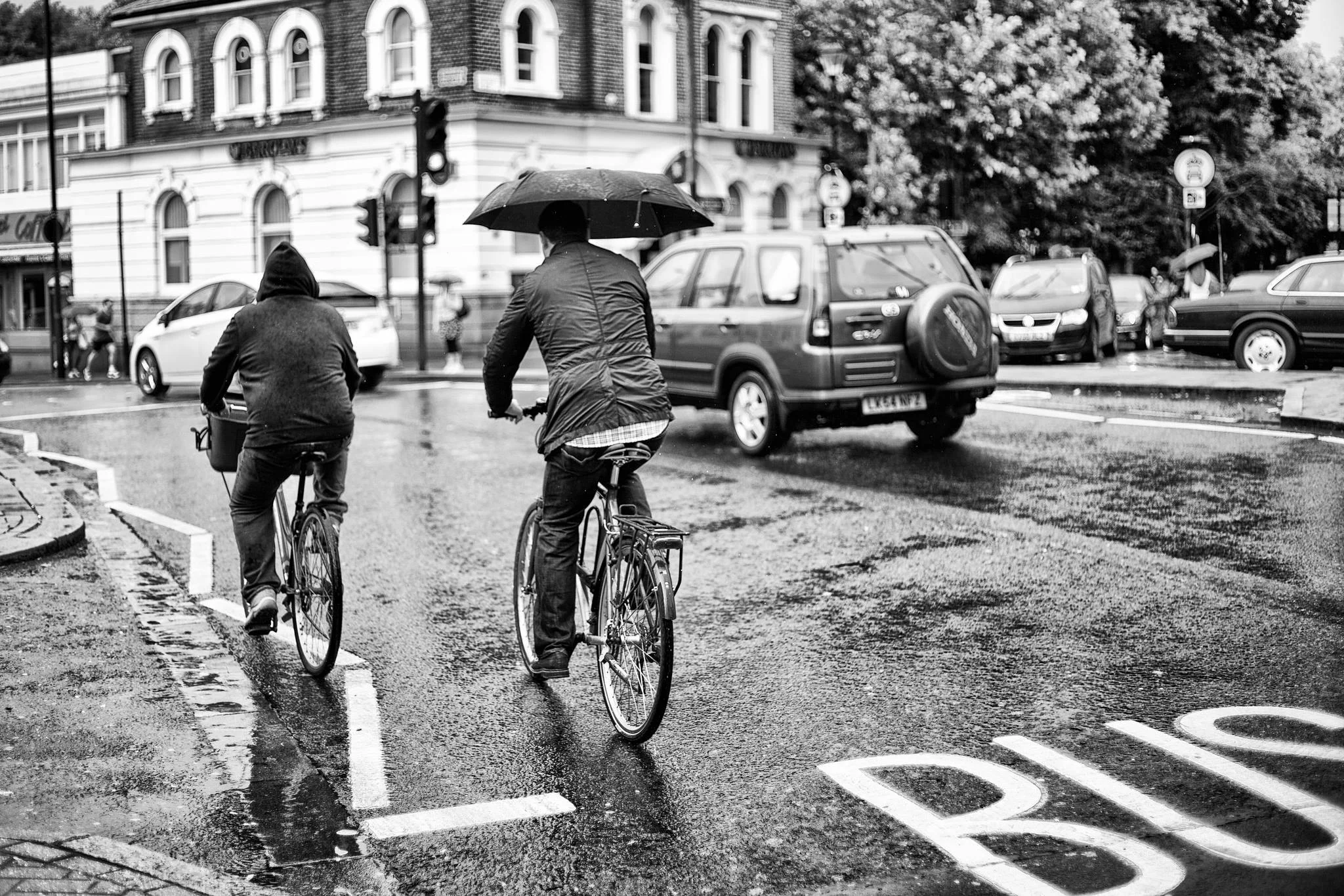 'Wet ride' Cyclists at Highbury corner, london.