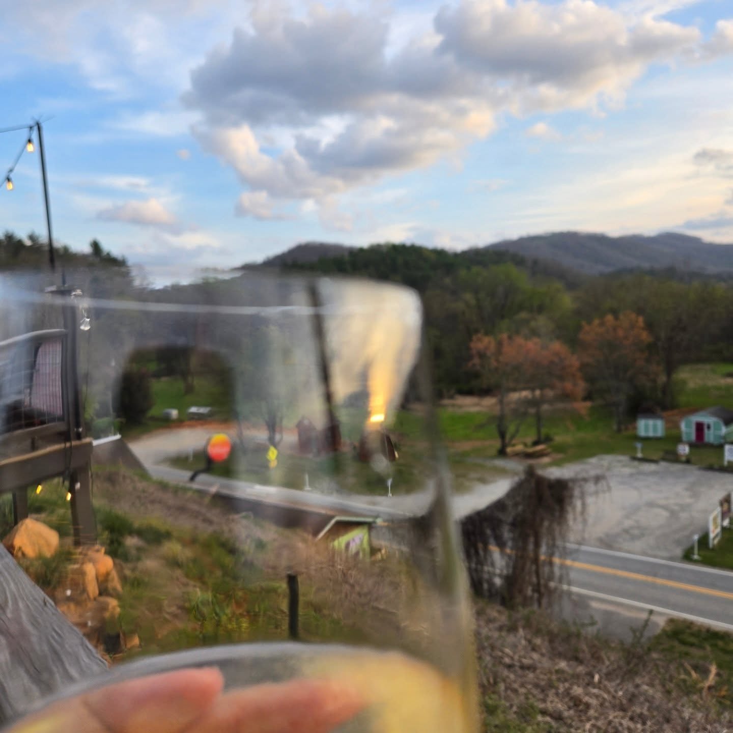 Enjoying the cool mountain breeze and a glass of Chardonnay while they setup for the Thursday night jam. #brasstownnc #johnccampbellfolkschool