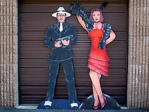 Gangsters- Make and Female, on heavy wood. About 7' tall.