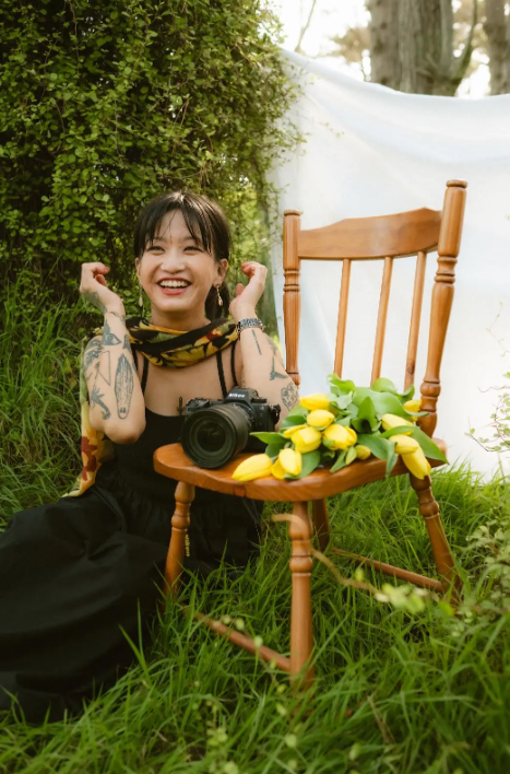 Kat sitting with her Camera and Lense