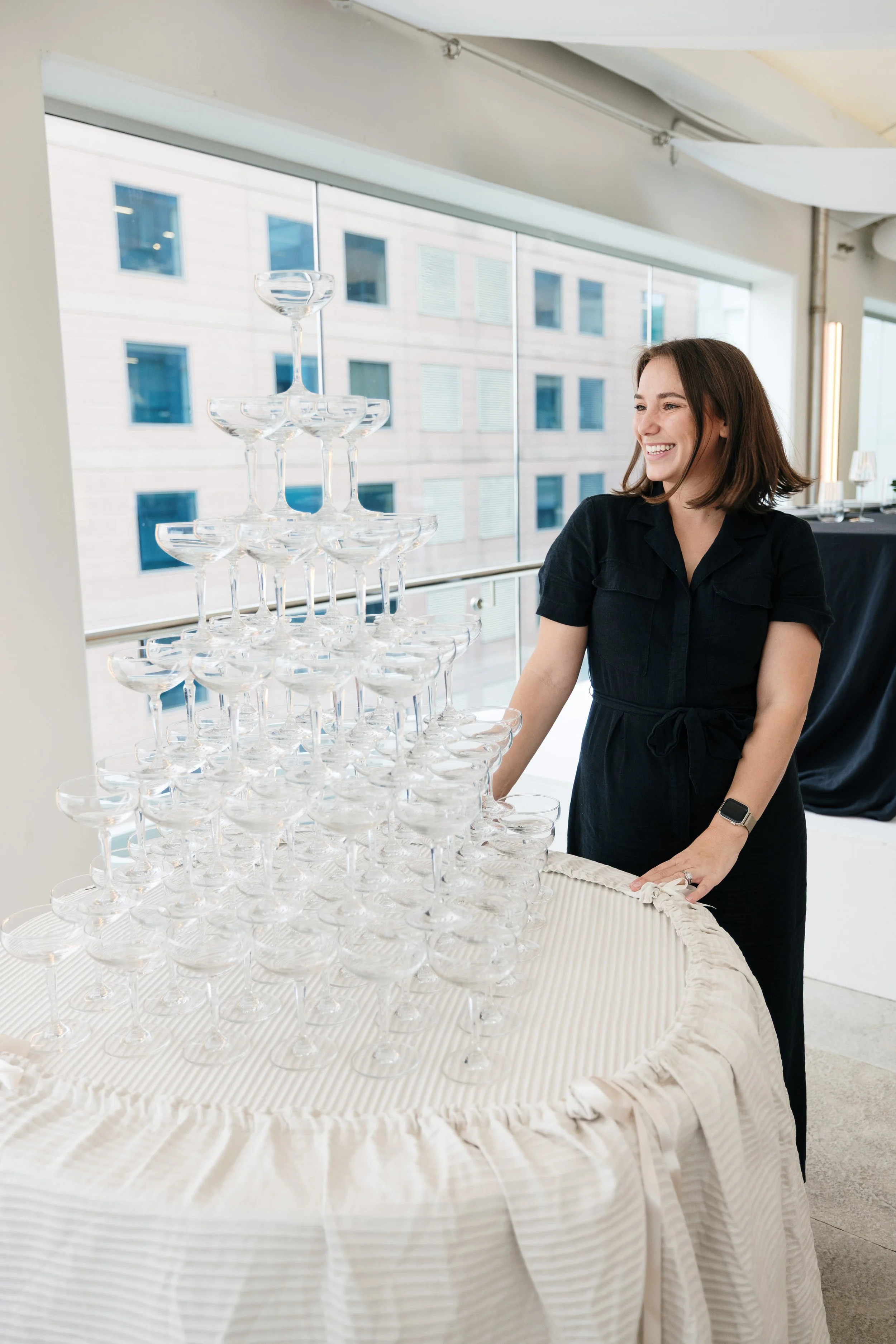 Makenzie standing with a Champagne Tower