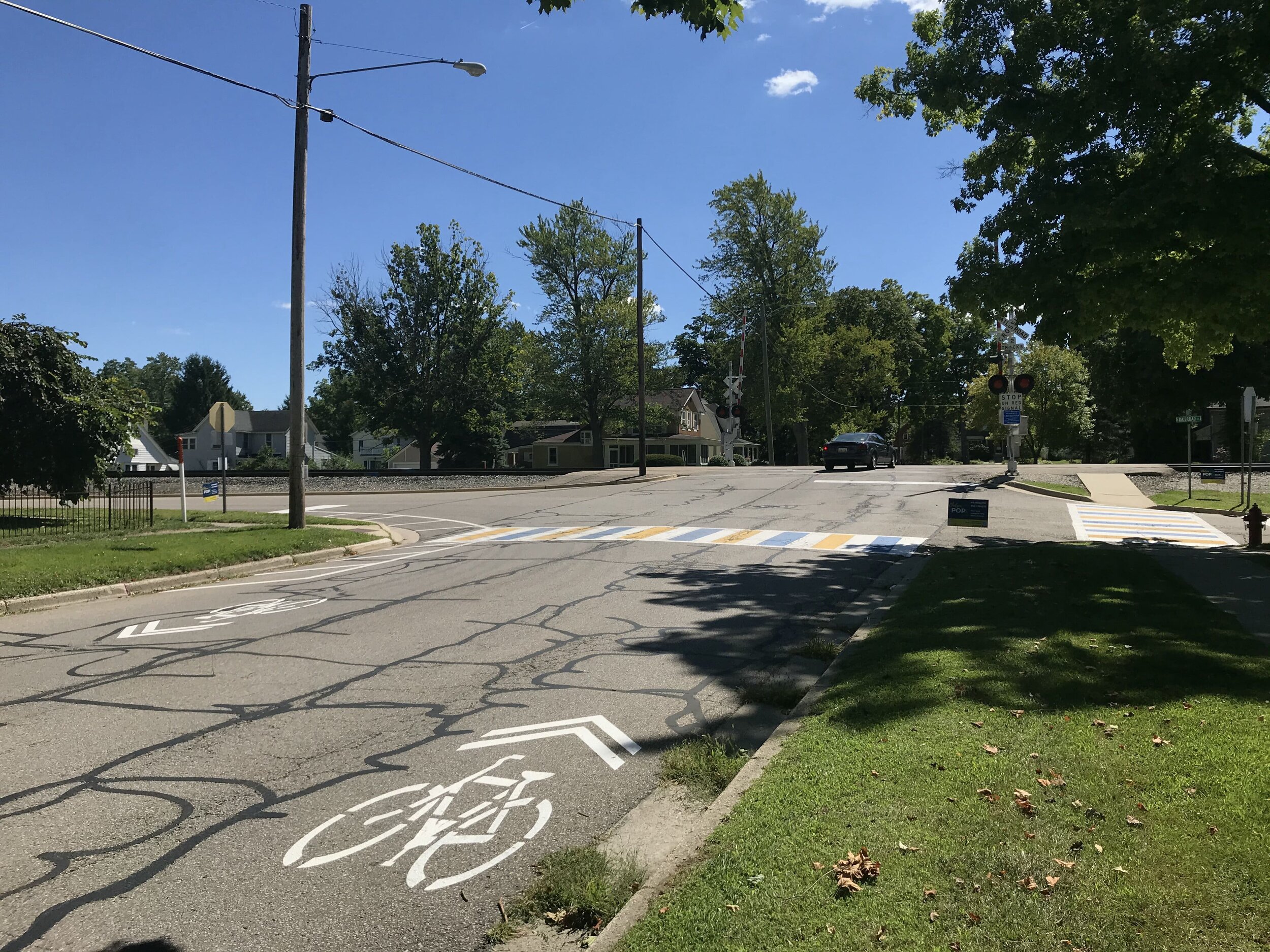  McKinley Street at Railroad Street improvements include sharrows, painted crosswalks, curb extensions, widened stop bars, and wayfinding signs. 