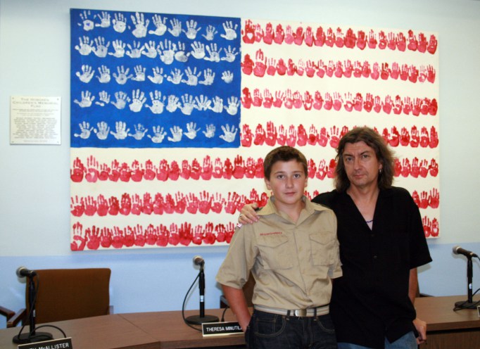 My son Charlie and I with the Hoboken Children’s Memorial Flag at the Hoboken Board of Education meeting room.