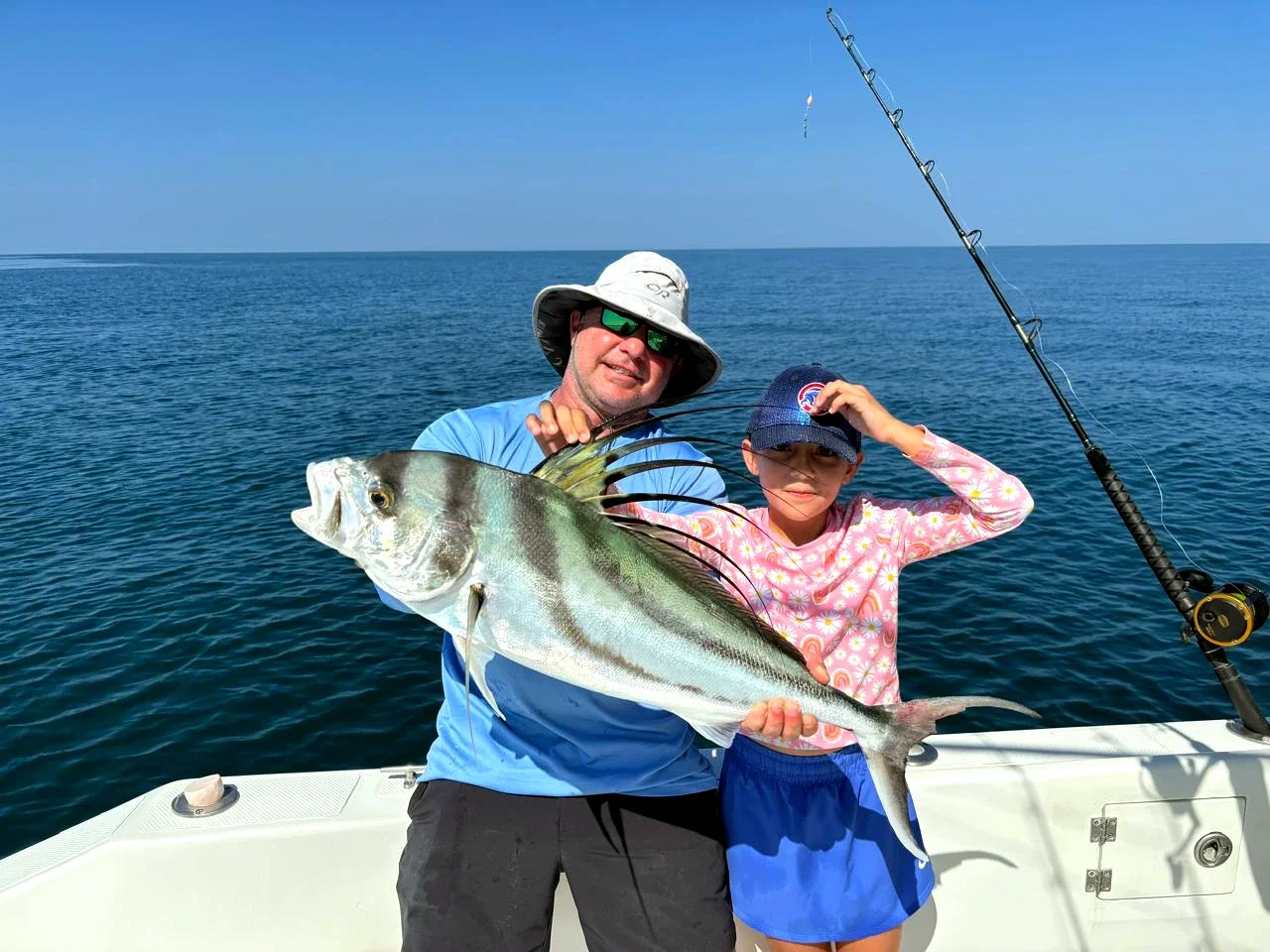 Family roosterfish catch during a Mal Pais and Santa Teresa fishing charter excursion in Costa Rica