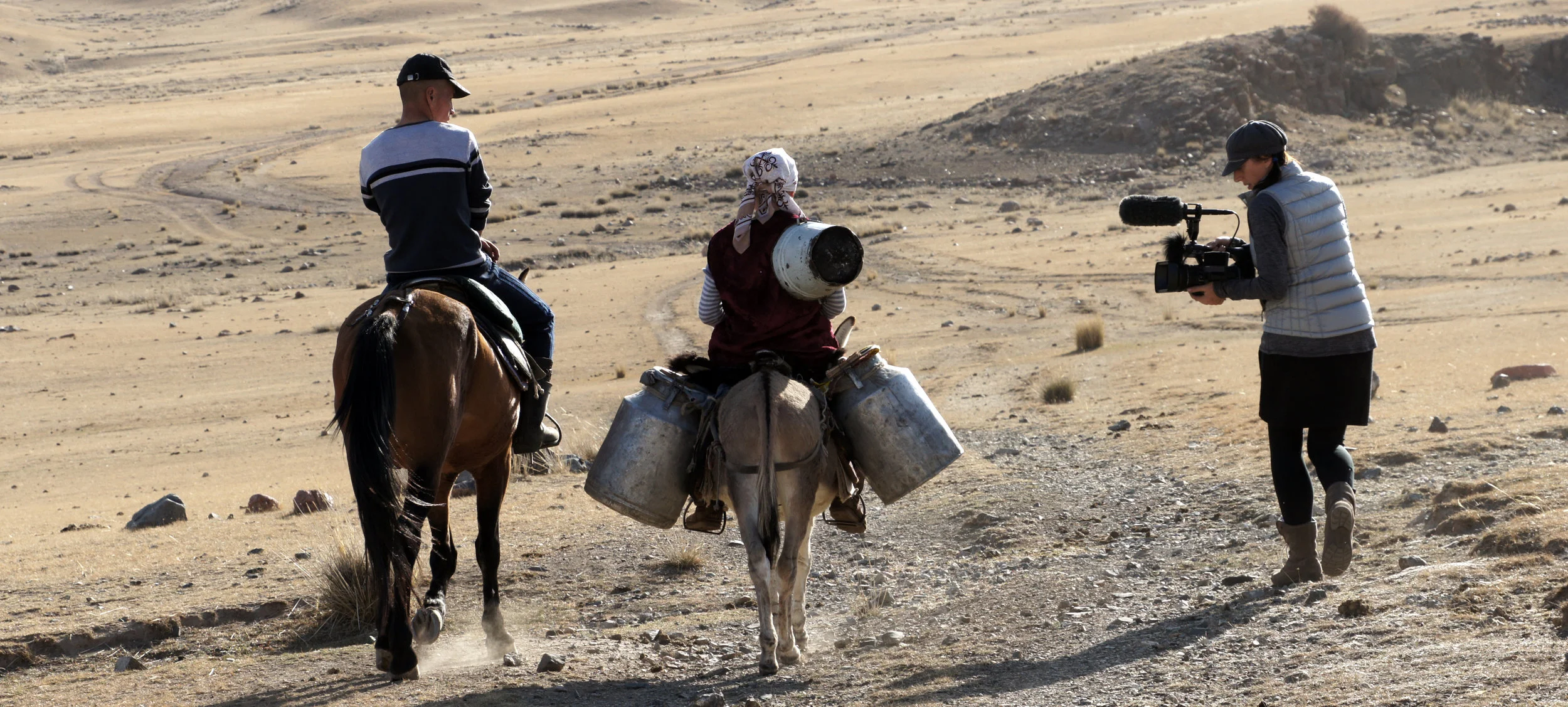 Urmat and Ayker collecting water, with filmmaker Sophie Dia Pegrum.