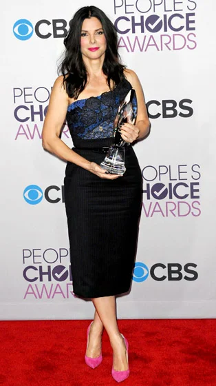 Credit: Albert L. Ortega/Getty At the 2013 People's Choice Awards, Heat actress Sandra Bullock donned a custom blue and black strapless corset with hand-appliqued lace and asymmetric horsehair accents. She paired it with the label's wool pencil skirt featuring gray chalk pinstripes and a patent leather belt. Read more: http://www.usmagazine.com/celebrity-style/pictures/hollywoods-hottest-fashion-designers-2013192/28605#ixzz3mlwQNnTr 