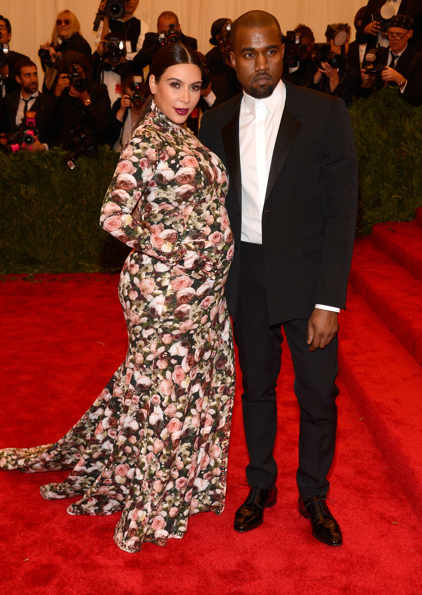 Image Source: Getty / Kevin Mazur Kim Kardashian The then Mom-to-be Kim Kardashian 's floral Givenchy by Riccardo Tisci gown will likely go down in history as one of the most talked-about maternity looks of all time. Her custom look for the 2013 Met Gala featured gloved long sleeves and a thigh-high slit. 