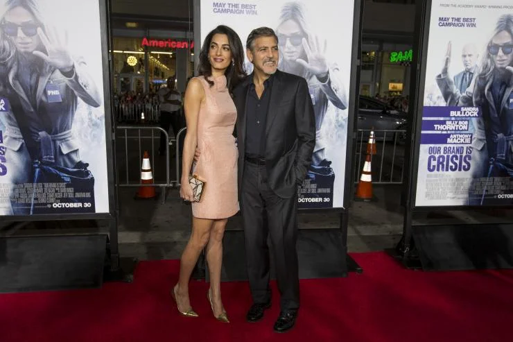 Producer George Clooney and his wife Amal pose at the premiere of "Our Brand Is Crisis" in Hollywood, California October 26, 2015. The movie opens in the U.S. on October 30. REUTERS/Mario Anzuoni