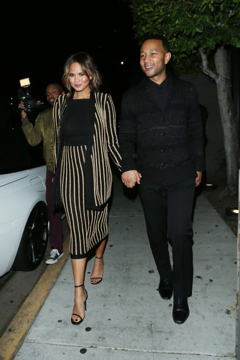 In a striped Balmain skirt suit while out to dinner with John Legend in LA. SPLASH
