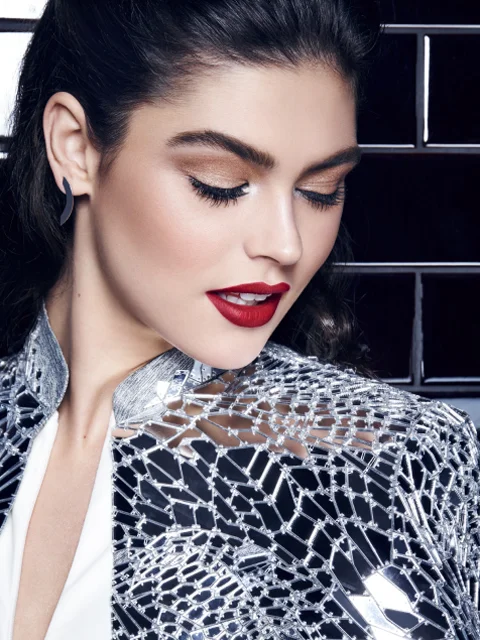 This holiday season, you’re coveting a little nocturnal adventure. Your uptown holiday affair may be winding down, but the night is still young. For this, you’ll need ruby red lips, dramatically pushed up lashes, and iridescent accessories that catch every eye in the room. Create a hot, red pout with Color Sensational lip color in ‘Rich Ruby, give your eyes a dazzling shimmer with The Nudes Palette, and push your lashes all the way up to the ceiling with The Falsies Push Up Drama mascara.