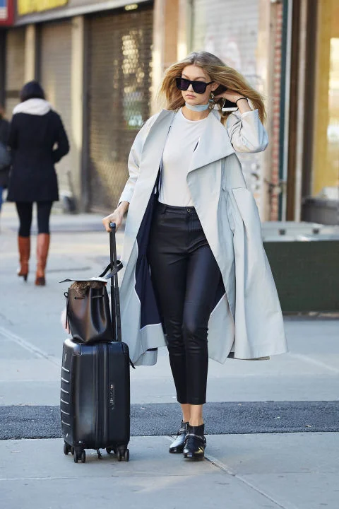 In a Toni Maticevski overcoat, Topshop leather leggings, Solsana Shoes booties and Karen Walker sunglasses while out in NYC. SPLASH