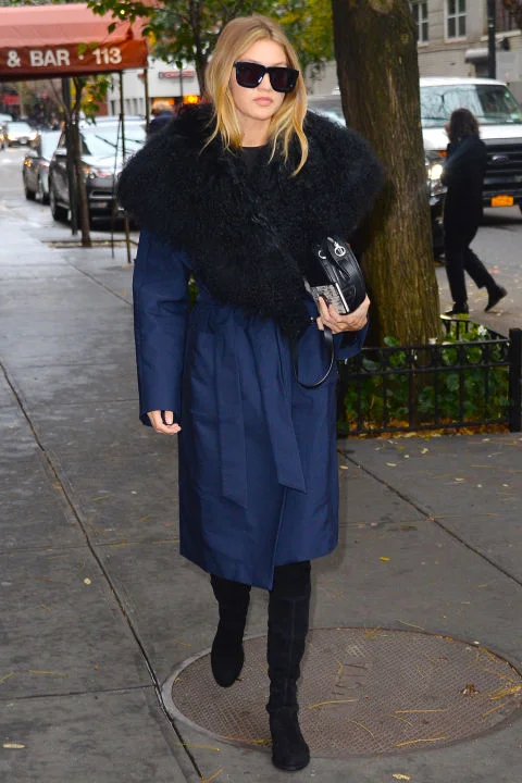 The model bundles up while in New York wearing a navy fur collared Kempner coat and accessorizing the look with Karen Walker sunnies.