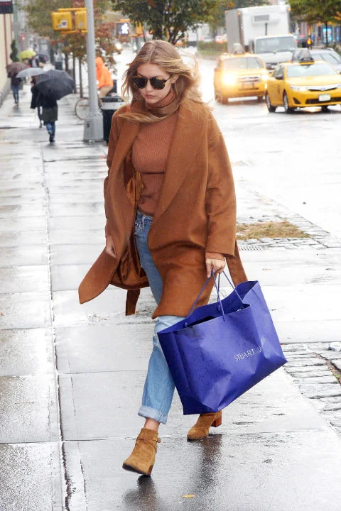Hadid takes up the camel trend in an Everlane turtleneck on a rainy day in New York. GETTY