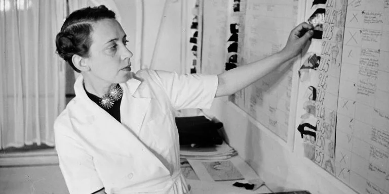 Schiaparelli's signature hand-knit trompe l'oeil sweater began her career in fashion in 1927. It was an instant best-seller and defined her style: high-end, well-fitting pieces with a twist of the unexpected. She was the first to use zippers as a visible statement piece, and she made her mark collaborating with fine artists such as Salvador Dali and Meret Oppenheim. Her unique style landed her a cover for TIME magazine, the first female fashion designer to ever earn the honor.