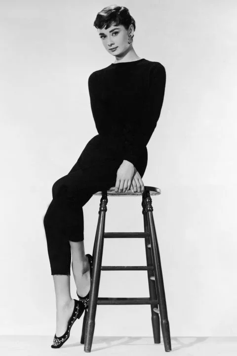 Audrey Hepburn The chic actress was a major fashion influencer—particularly when she partnered with Hubert de Givenchy and Edith Head for films like Funny Face and Sabrina . She popularized straight, black-cropped pants, boatneck tops, and comfortable slip-on loafers designed by none other than Ferragamo. She made Holly Golightly an icon in the film Breakfast at Tiffany's , a fashion favorite forever. GETTY