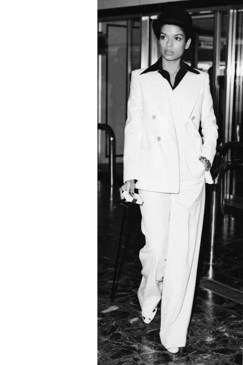 Bianca Jagger Part of the high-glam '70s and a staple of Studio 54, Bianca Jagger had a style all her own. She favored sequined sheaths, fur, high-waisted pants, crisp suits, and blouses that were unbuttoned as could be. She mixed and matched old pieces with the new (think wide-legged pants with a revealing top, turban, and sleek, black choker) in a way that was thoroughly modern and entirely rock and roll. GETTY
