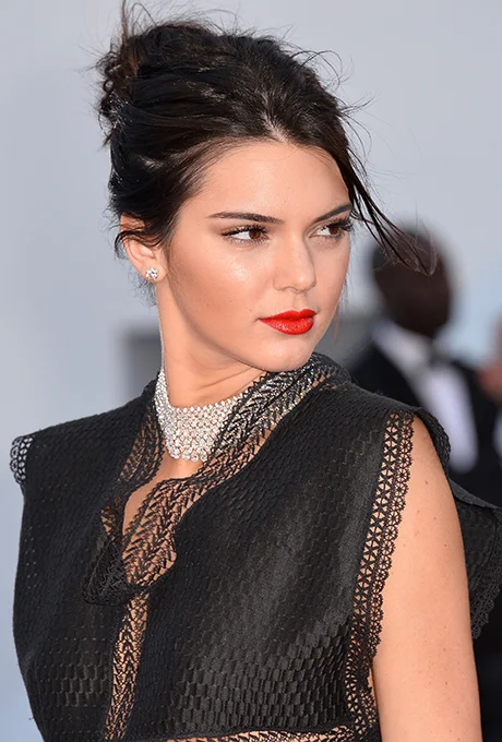 Kendall Jenner Kendall proves a bold red lip doesn't need much to look killer — just a dab of mascara and loosely pulled back updo will do.
