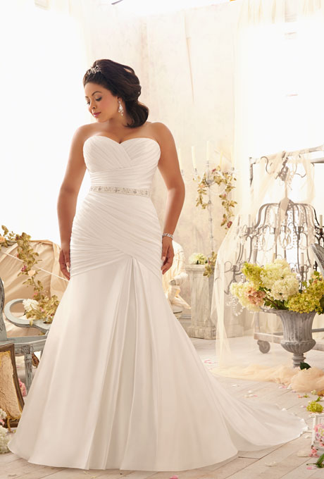 Photo: Courtesy of Mori Lee Style 3154, asymmetrically draped soft satin with crystal beaded tie sash and corset back, $870, Mori Lee See more Mori Lee wedding dresses.