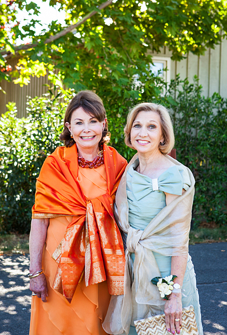 Dare and Garrick's formal "California casual-meets-Old South" wedding took place at the Carneros Inn in Napa, California. The mothers of the bride and groom posed for this adorable photo in their festive, tiered dresses and shawls. The mother-of-the-bride's vibrant coral dress was purchased from Wilkes Bashford boutique in San Francisco. See more orange mother-of-the-bride dresses. View more photos from Dare and Garrick's wedding. Photo: Kate Webber Photography