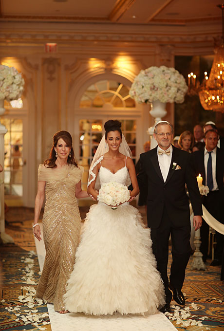 Mallorie and Dan got married in a classic black-tie wedding at New York City's Essex House. The July affair in the beaux arts setting required glamorous attire, and Mallorie's mother's gold-sequined, floor-length gown with its tulle shoulder covering fit the bill. Though the dress was luxe, the bride's tulle Monique Lhuillier ball gown still took center stage. See more floor-length mother-of-the-bride dresses. View more photos from Mallorie and Dan's wedding. Photo: Alison Conklin Photography