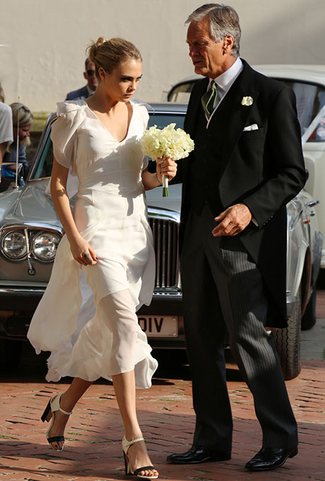 The supermodel pulled a Pippa Middleton while serving as her big sister Poppy's maid of honor last May , donning a floor-length white Chanel gown with a flutter detail on the neckline and sleeves. We love how she kept the rest of the look understated, with a simple bun and killer shoes. Photo: Getty Images