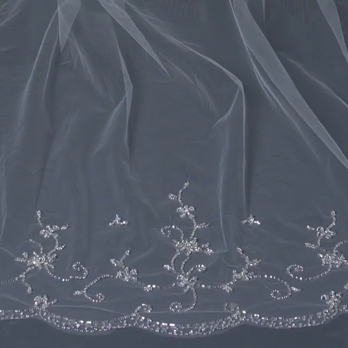 Beautiful single layer cathedral length bridal veil with hand sewn embroidery throughout the veil accented with faceted crystal like petals, sequins and clear and silver bugle beads throughout. This wedding veil is absolutely breathtaking. Length: 108" inch long x 71" inch wide
