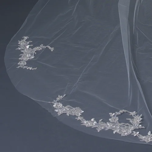 Beautiful single layer cathedral length bridal wedding veil with cut edge and embellished with delicately placed pale silver lace floral appliques accented with sequins and seed beads. Length: 108" inch long x 71" inch wide Available with a plain cut edge or with a bugle bead edge.