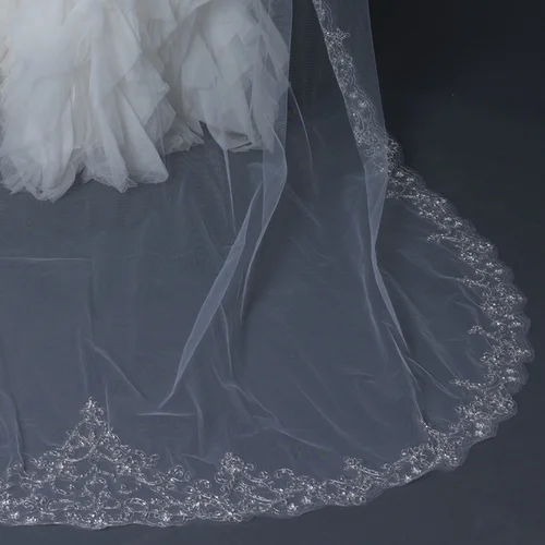 Stunning scalloped cathedral length bridal wedding veil accented with pale silver floral embroidery embellished with seed beads and rhinestones. Length: 108" inch long x 71" inch wide