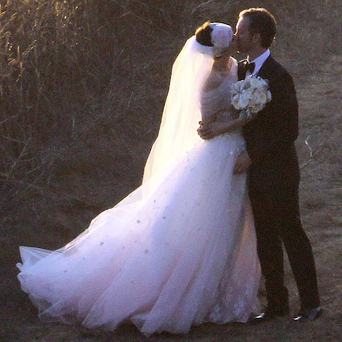 Photo: Getty Images Anne Hathaway Valentino Garavani came out of retirement to design his muse's wedding dress for her September 2012 wedding to Adam Schulman . The gown featured a gauzy, tulle overskirt and an elegant off-the-shoulder-neckline fashioned from the same fabric, all imbued with shades of blush pink. The dress, plus her lacy headpiece, created a dazzlingly romantic and whimsical look.