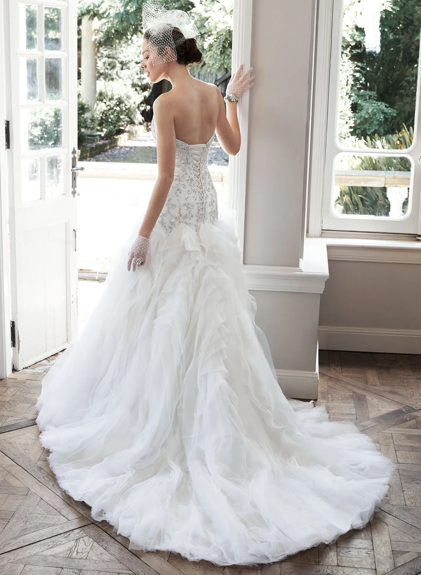 Glittering Swarovski crystals and pearls adorn the fitted bodice of this wedding dress, while dramatic folds of tulle and Chic organza create the stunning, voluminous skirt. Finished with sweetheart neckline and corset closure. Colors Available White/Silver Accent, Ivory/Silver Accent (shown)