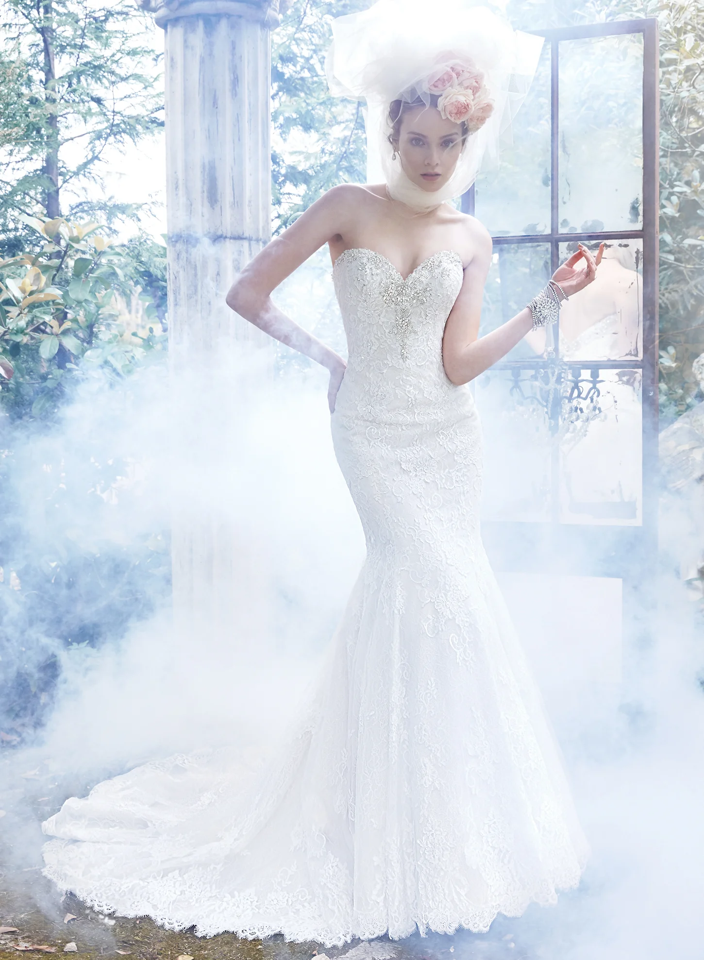 Glamorous Swarovski crystals adorn the romantic sweetheart neckline of this classic fit and flare wedding dress, comprised of tulle and hand-placed lace appliques, trailing the skirt and edging the hemline. Finished with corset closure. Colors Available White, Ivory, Ivory over Champagne (shown)