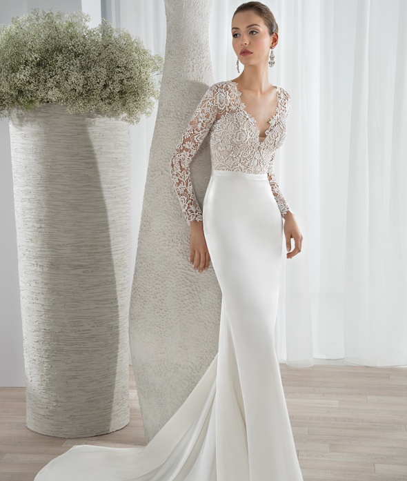 This sleek luxe satin sheath gown features a lace bodice with a plunging V-neckline and long lace sleeves. Transitioning to a high back with button closures and a sophisticated Chapel length train. Available Colors: Ivory/Nude/Natural, White/Nude/Natural, Ivory/Natural, White/Natural, Ivory/Nude, White/Nude, Ivory, White View Size Chart 