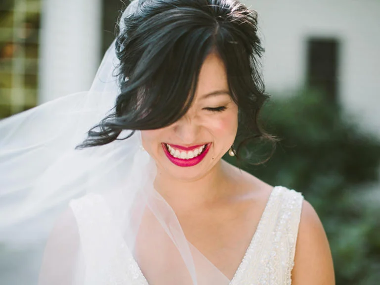 PHOTO BY JILL DEVRIES PHOTOGRAPHY Use your makeup to play up your favorite facial feature, like this bride did. A hot pink lipstick puts all eyes on her pout. From the album A Chic Fall Wedding at Windmill Island in Holland, Michigan